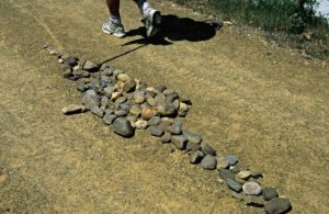 Arrow formed with stones on a path of the French Way