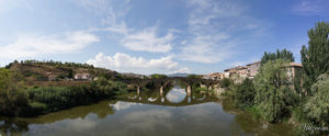 Image of the medieval bridge over a river at the exit of Puente la Reina