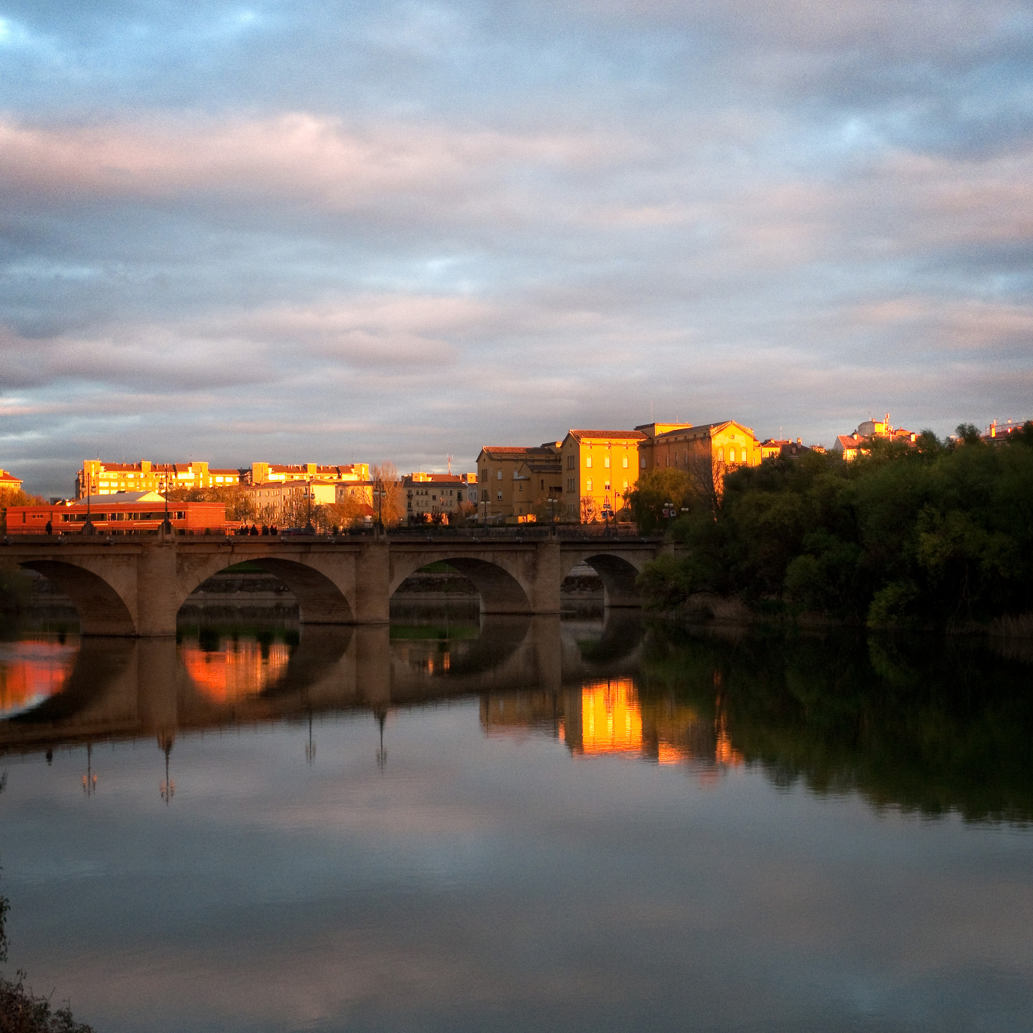 Logroño stone bridge over a river and during the sunset