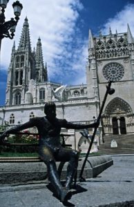 Statue of a pilgrim with the cathedral of Burgos in the background